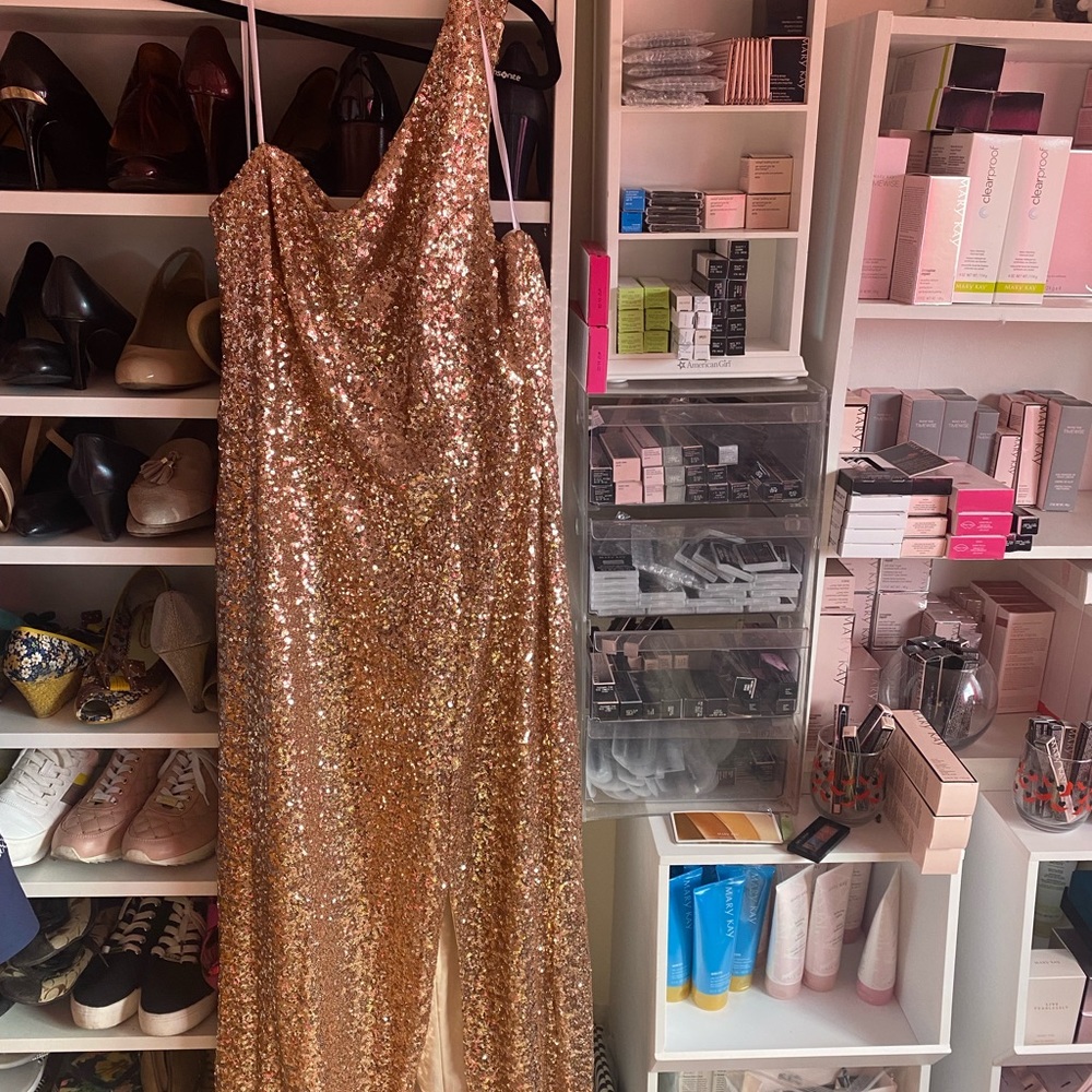 Full length gold sequence one shoulder gown.
